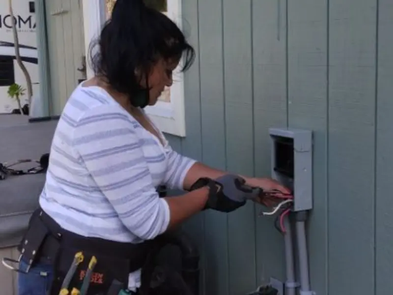 Licensed electrician wiring an exterior subpanel in Miramar Beach