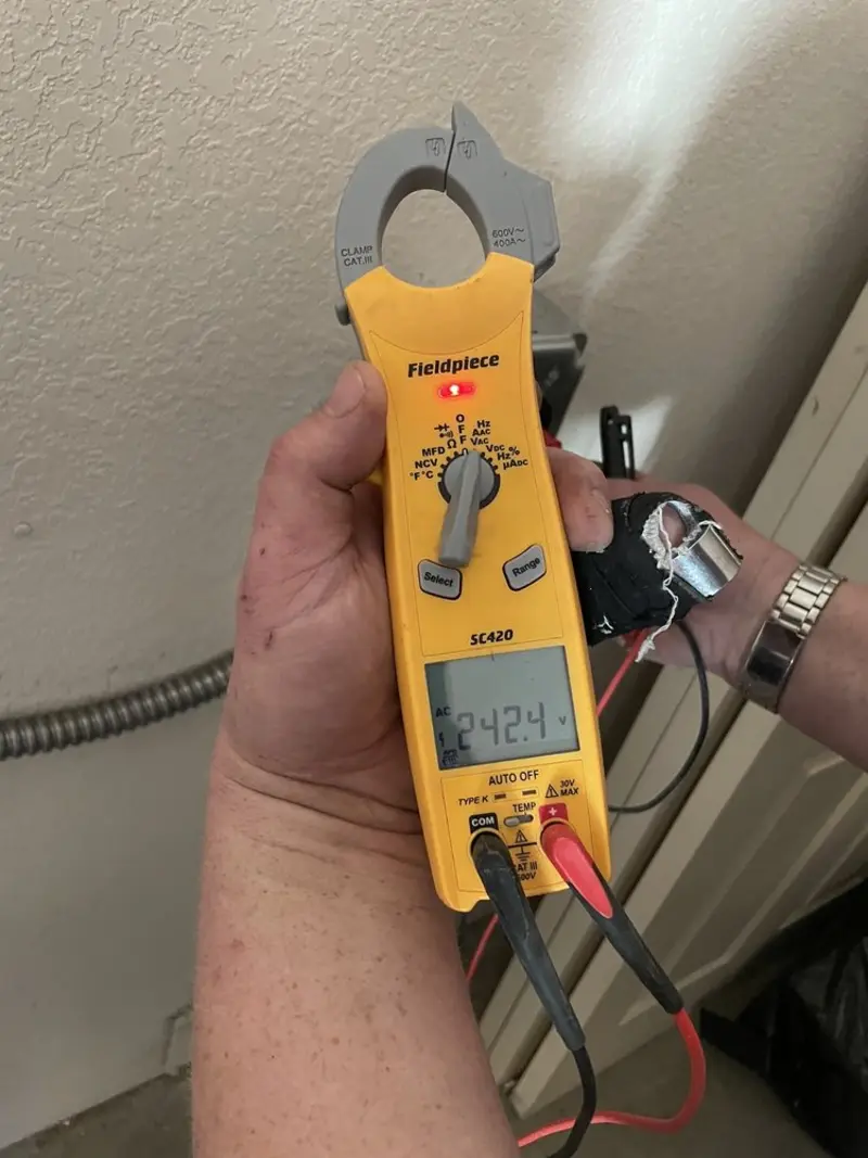 Voltage testing with clamp meter during Whole House Surge Protector in Miramar Beach